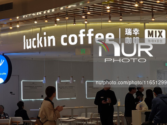 Customers shop at Luckin Coffee x Tea Mix store in Shanghai, China, on October 9, 2024. (