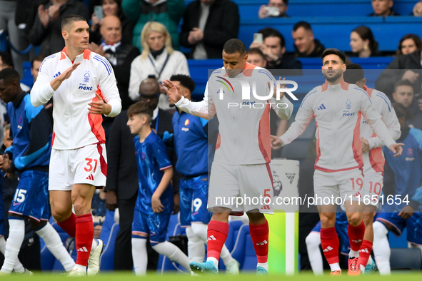 Nikola Milenkovic, Murillo, and Alex Moreno of Nottingham Forest walk onto the pitch ahead of the Premier League match between Chelsea and N...