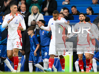 Nikola Milenkovic, Murillo, and Alex Moreno of Nottingham Forest walk onto the pitch ahead of the Premier League match between Chelsea and N...