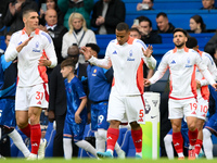 Nikola Milenkovic, Murillo, and Alex Moreno of Nottingham Forest walk onto the pitch ahead of the Premier League match between Chelsea and N...