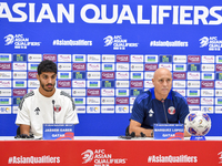 Qatar national team Head Coach Marquez Lopez (L) and player Jassim Jaber (R) attend a press conference at Al Thumama Stadium in Doha, Qatar,...