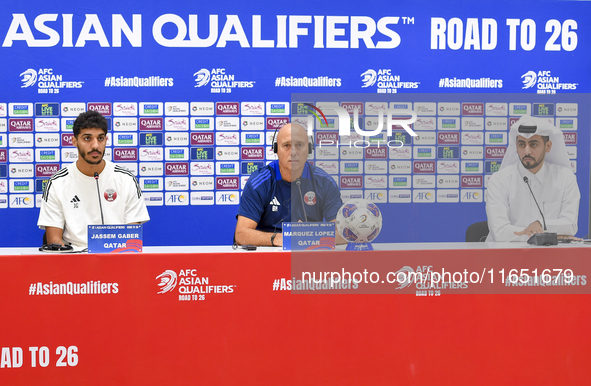 Qatar national team Head Coach Marquez Lopez (C) and player Jassim Jaber (R) attend a press conference at Al Thumama Stadium in Doha, Qatar,...