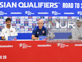 Qatar national team Head Coach Marquez Lopez (C) and player Jassim Jaber (R) attend a press conference at Al Thumama Stadium in Doha, Qatar,...