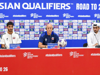 Qatar national team Head Coach Marquez Lopez (C) and player Jassim Jaber (R) attend a press conference at Al Thumama Stadium in Doha, Qatar,...