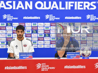 Qatar national team Head Coach Marquez Lopez (L) and player Jassim Jaber (R) attend a press conference at Al Thumama Stadium in Doha, Qatar,...