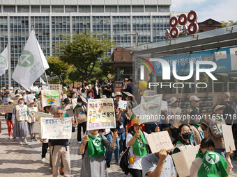 Hundreds of Catholic priests, nuns, and members of the Catholic Climate Action group march in central Seoul, starting from Myeongdong Cathed...