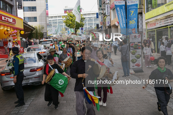 Hundreds of Catholic priests, nuns, and members of the Catholic Climate Action group march in central Seoul, starting from Myeongdong Cathed...