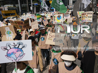 Hundreds of Catholic priests, nuns, and members of the Catholic Climate Action group march in central Seoul, starting from Myeongdong Cathed...