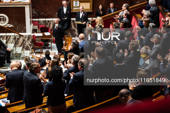 Socialist deputies stand and applaud the speech of their Secretary General, Olivier Faure, in Parliament on the occasion of the no-confidenc...