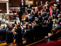 Socialist deputies stand and applaud the speech of their Secretary General, Olivier Faure, in Parliament on the occasion of the no-confidenc...