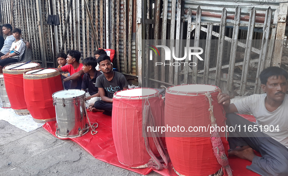 Traditional drummers play their instruments at the Siliguri Town railway station as they wait to be hired to perform for the Hindu festival...