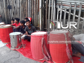 Traditional drummers play their instruments at the Siliguri Town railway station as they wait to be hired to perform for the Hindu festival...