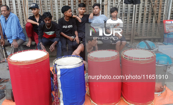 Traditional drummers play their instruments at the Siliguri Town railway station as they wait to be hired to perform for the Hindu festival...