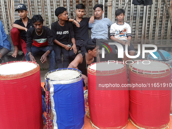 Traditional drummers play their instruments at the Siliguri Town railway station as they wait to be hired to perform for the Hindu festival...