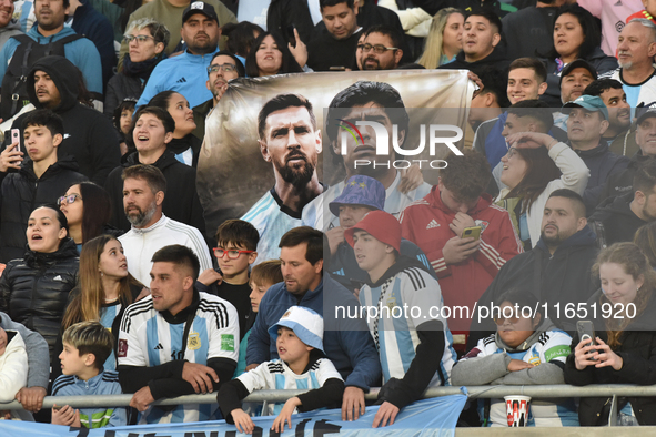 Argentina's fans hold a Lionel Messi and Diego Maradona flag before a World Cup Qualifiers match between Argentina and Paraguay at Estadio M...