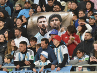 Argentina's fans hold a Lionel Messi and Diego Maradona flag before a World Cup Qualifiers match between Argentina and Paraguay at Estadio M...