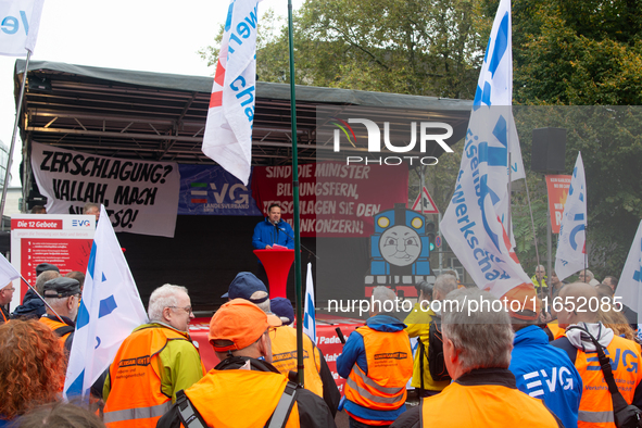 Neithard von Bohlen, chairman of the EVG regional association of North Rhine-Westphalia, speaks on the stage as members from the EVG railway...