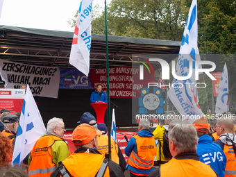 Neithard von Bohlen, chairman of the EVG regional association of North Rhine-Westphalia, speaks on the stage as members from the EVG railway...