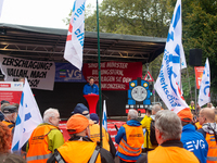 Neithard von Bohlen, chairman of the EVG regional association of North Rhine-Westphalia, speaks on the stage as members from the EVG railway...