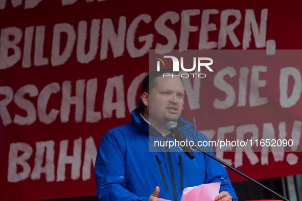 Neithard von Bohlen, chairman of the EVG regional association of North Rhine-Westphalia, speaks on the stage as members from the EVG railway...