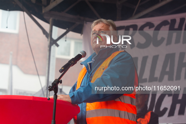 Martin Burkert, chairman of the EVG union, speaks on the stage as members from the EVG railway workers rally against the federal transportat...