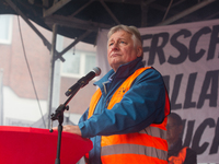 Martin Burkert, chairman of the EVG union, speaks on the stage as members from the EVG railway workers rally against the federal transportat...