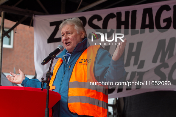 Martin Burkert, chairman of the EVG union, speaks on the stage as members from the EVG railway workers rally against the federal transportat...