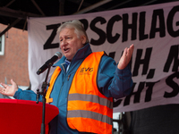 Martin Burkert, chairman of the EVG union, speaks on the stage as members from the EVG railway workers rally against the federal transportat...