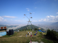 Nepali people play on a swing installed on a hillside surrounding Kathmandu Valley with the arrival of the fortnightly festival of Dashain,...