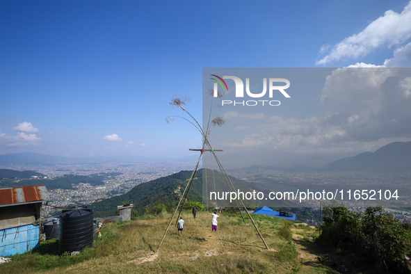 A Nepali woman plays on a swing installed on a hillside surrounding Kathmandu Valley with the arrival of the fortnightly festival of Dashain...