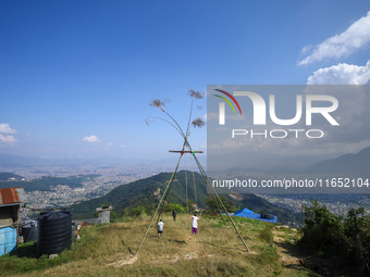 A Nepali woman plays on a swing installed on a hillside surrounding Kathmandu Valley with the arrival of the fortnightly festival of Dashain...