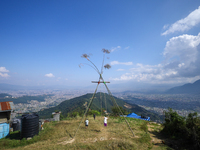 A Nepali woman plays on a swing installed on a hillside surrounding Kathmandu Valley with the arrival of the fortnightly festival of Dashain...