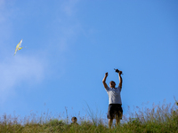 A Nepali man flies a kite from a hilltop surrounding Kathmandu Valley with the arrival of the fortnightly festival of Dashain, on October 9,...