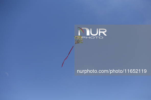 A kite takes flight in the clear blue sky above Kathmandu, Nepal, on October 9, 2024, as the weather clears with the arrival of the fortnigh...