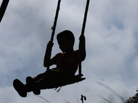 A Nepali boy plays on a swing installed on a hillside surrounding Kathmandu Valley with the arrival of the fortnightly festival of Dashain,...