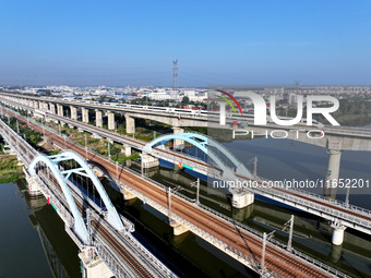 A bullet train runs on a railway bridge in Lianyungang, China, on October 9, 2024. (