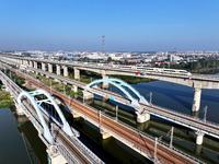 A bullet train runs on a railway bridge in Lianyungang, China, on October 9, 2024. (