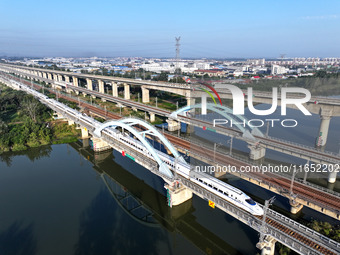 A bullet train runs on a railway bridge in Lianyungang, China, on October 9, 2024. (