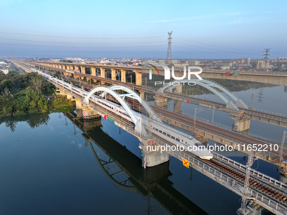 A bullet train runs on a railway bridge in Lianyungang, China, on October 9, 2024. 