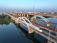 A bullet train runs on a railway bridge in Lianyungang, China, on October 9, 2024. (