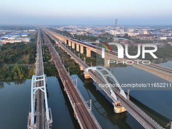 A bullet train runs on a railway bridge in Lianyungang, China, on October 9, 2024. (