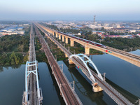 A bullet train runs on a railway bridge in Lianyungang, China, on October 9, 2024. (