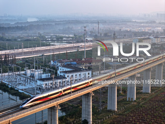 A bullet train runs in Lianyungang, China, on October 9, 2024. (