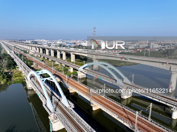 A bullet train runs on a railway bridge in Lianyungang, China, on October 9, 2024. 