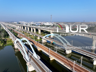 A bullet train runs on a railway bridge in Lianyungang, China, on October 9, 2024. (