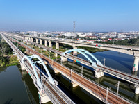 A bullet train runs on a railway bridge in Lianyungang, China, on October 9, 2024. (