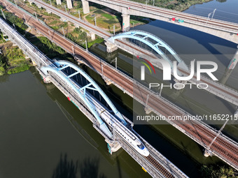 A bullet train runs on a railway bridge in Lianyungang, China, on October 9, 2024. (