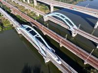 A bullet train runs on a railway bridge in Lianyungang, China, on October 9, 2024. (