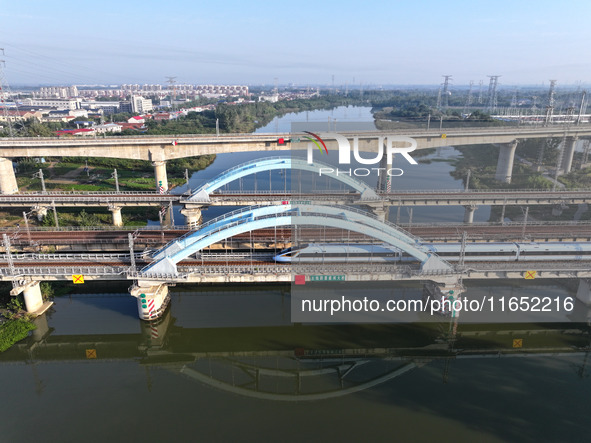 A bullet train runs on a railway bridge in Lianyungang, China, on October 9, 2024. 