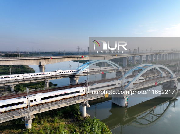 A bullet train runs on a railway bridge in Lianyungang, China, on October 9, 2024. 